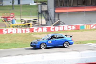 Blue Subaru at Mid-Ohio start/finish line